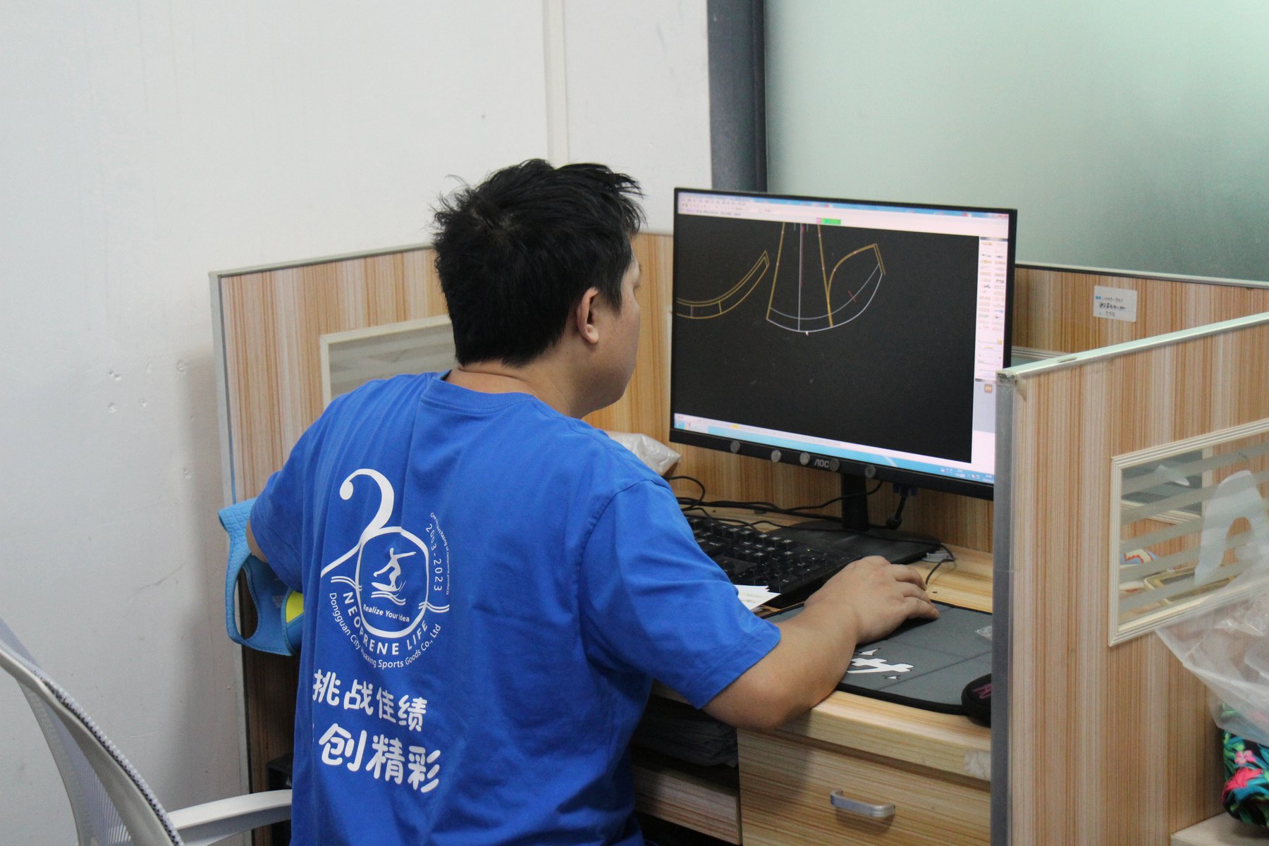 Huatop development team member reviewing neoprene product pattern artwork
