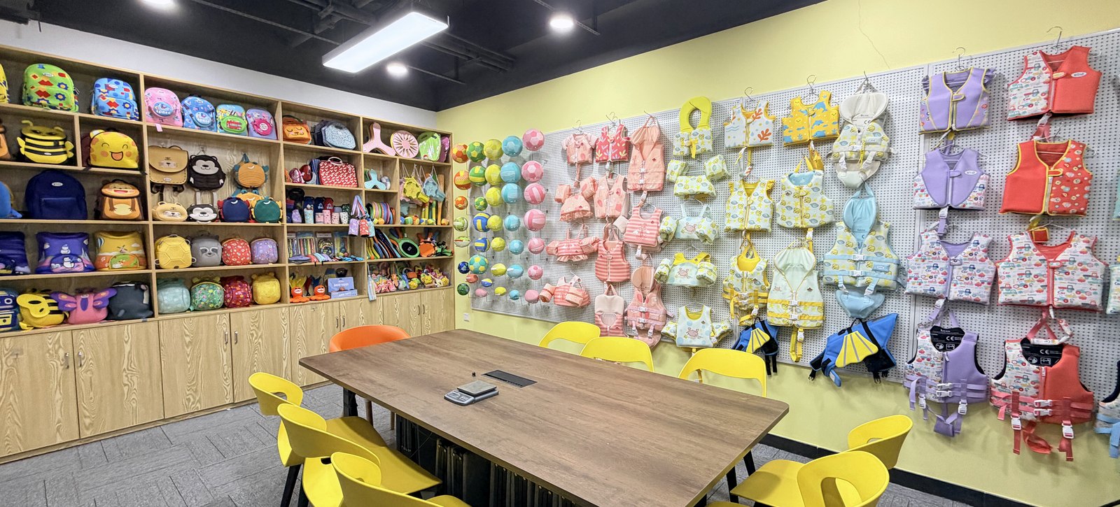 Huatop sample room with neoprene swim vests, bags and product displays